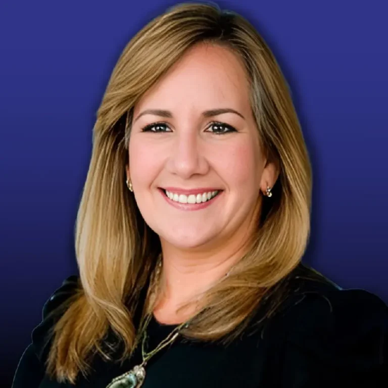 Monica Díaz professional headshot smiling against blue background